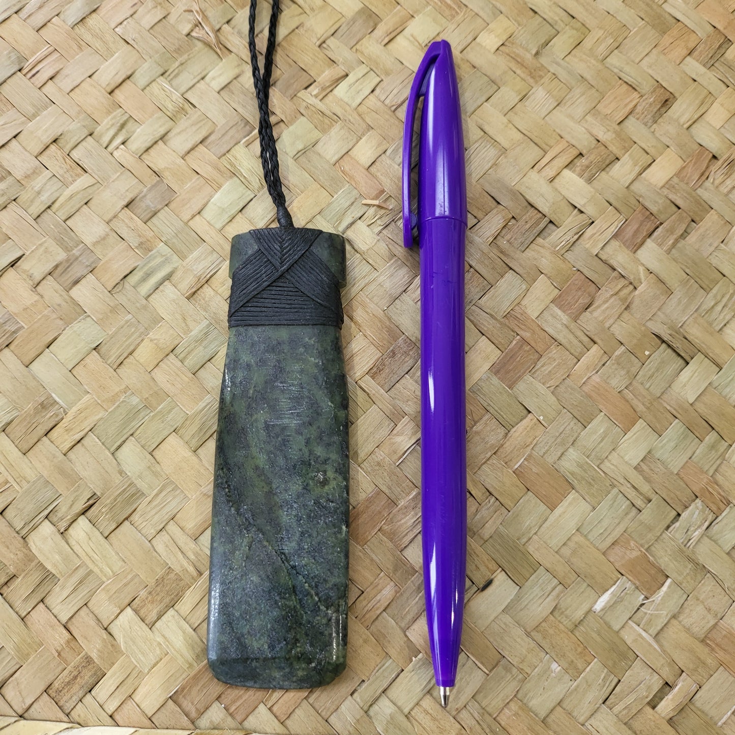 carved pounamu toki (adze) necklace, on black cord