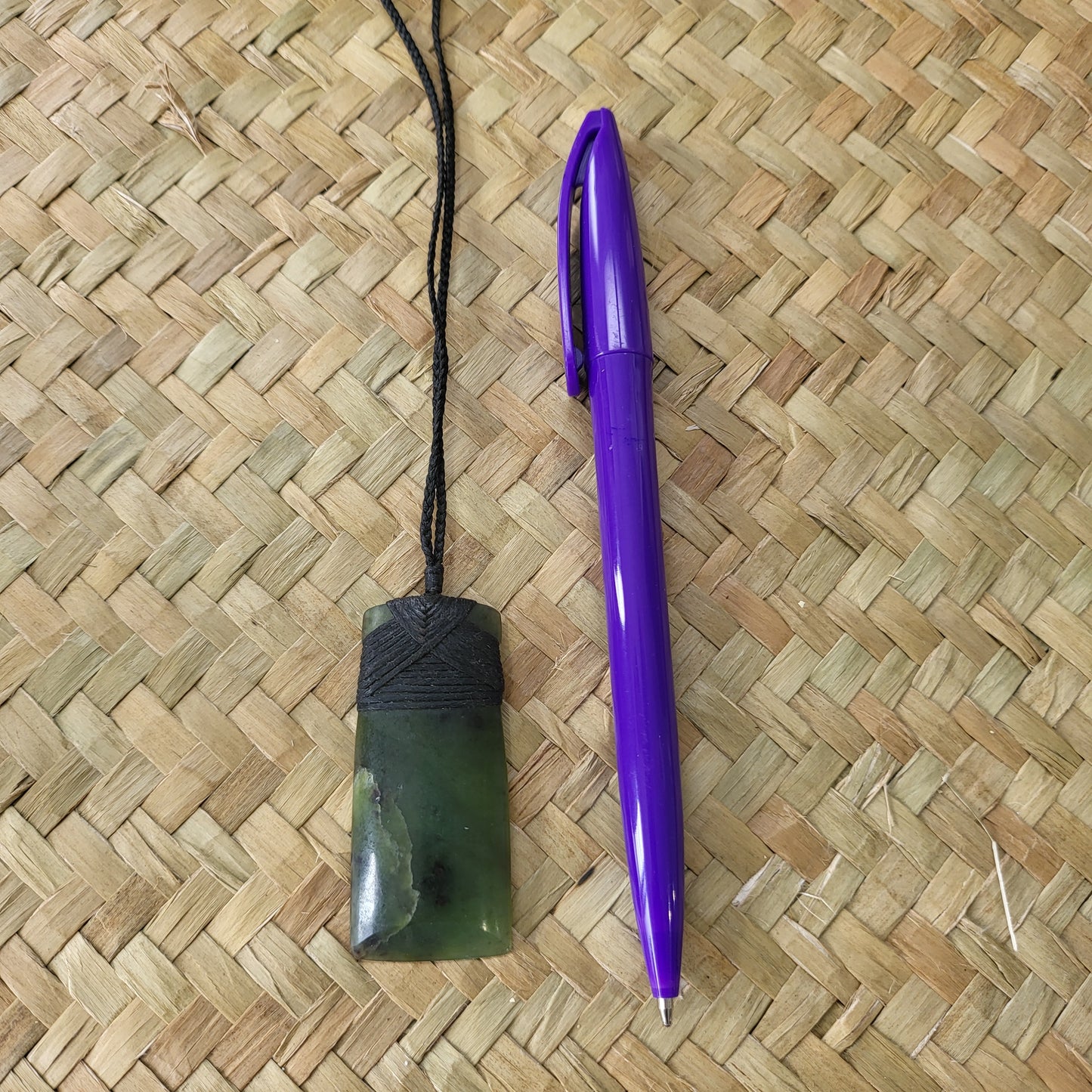 carved pounamu toki (adze) necklace, beautiful colour variations, on black cord