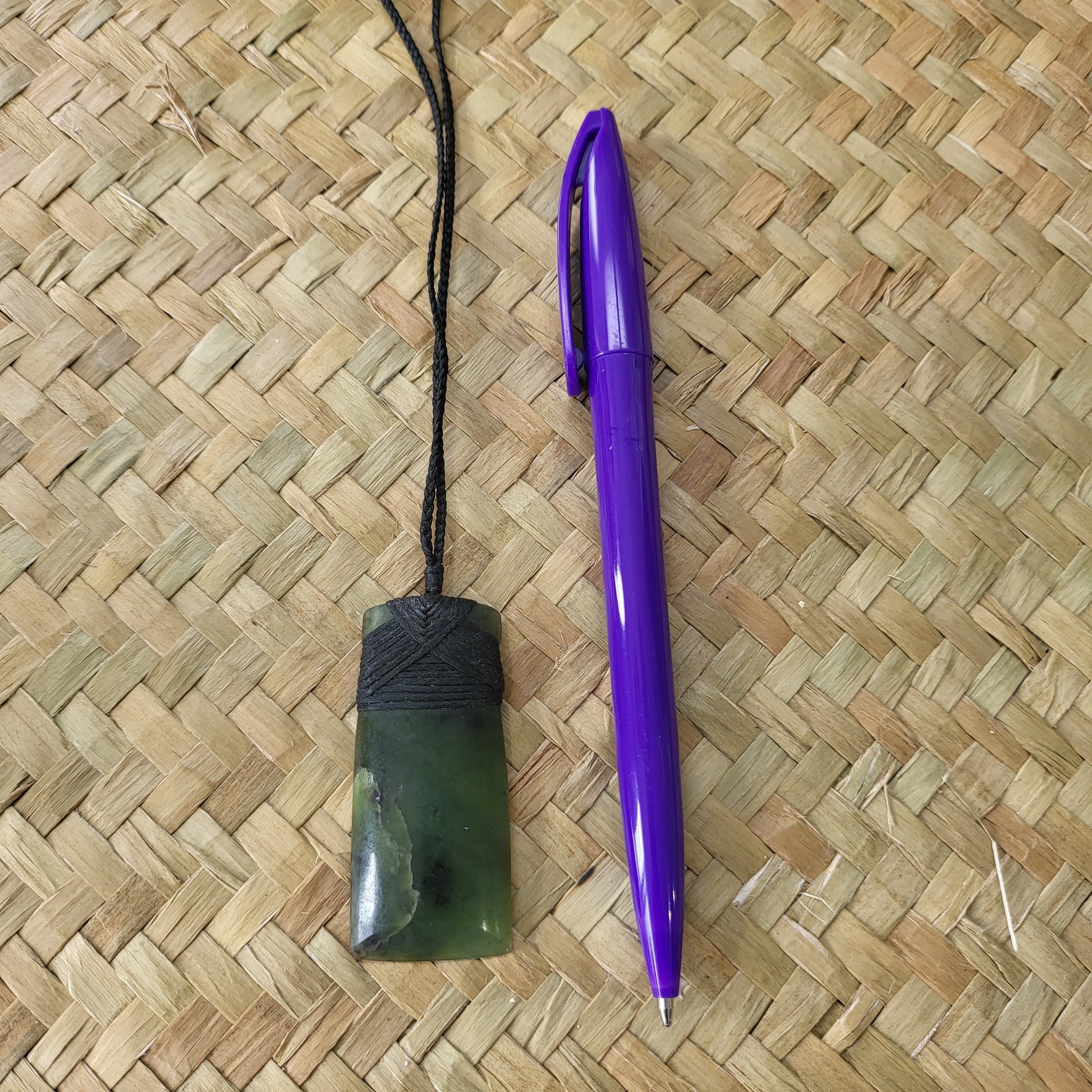 carved pounamu toki (adze) necklace, beautiful colour variations, on black cord