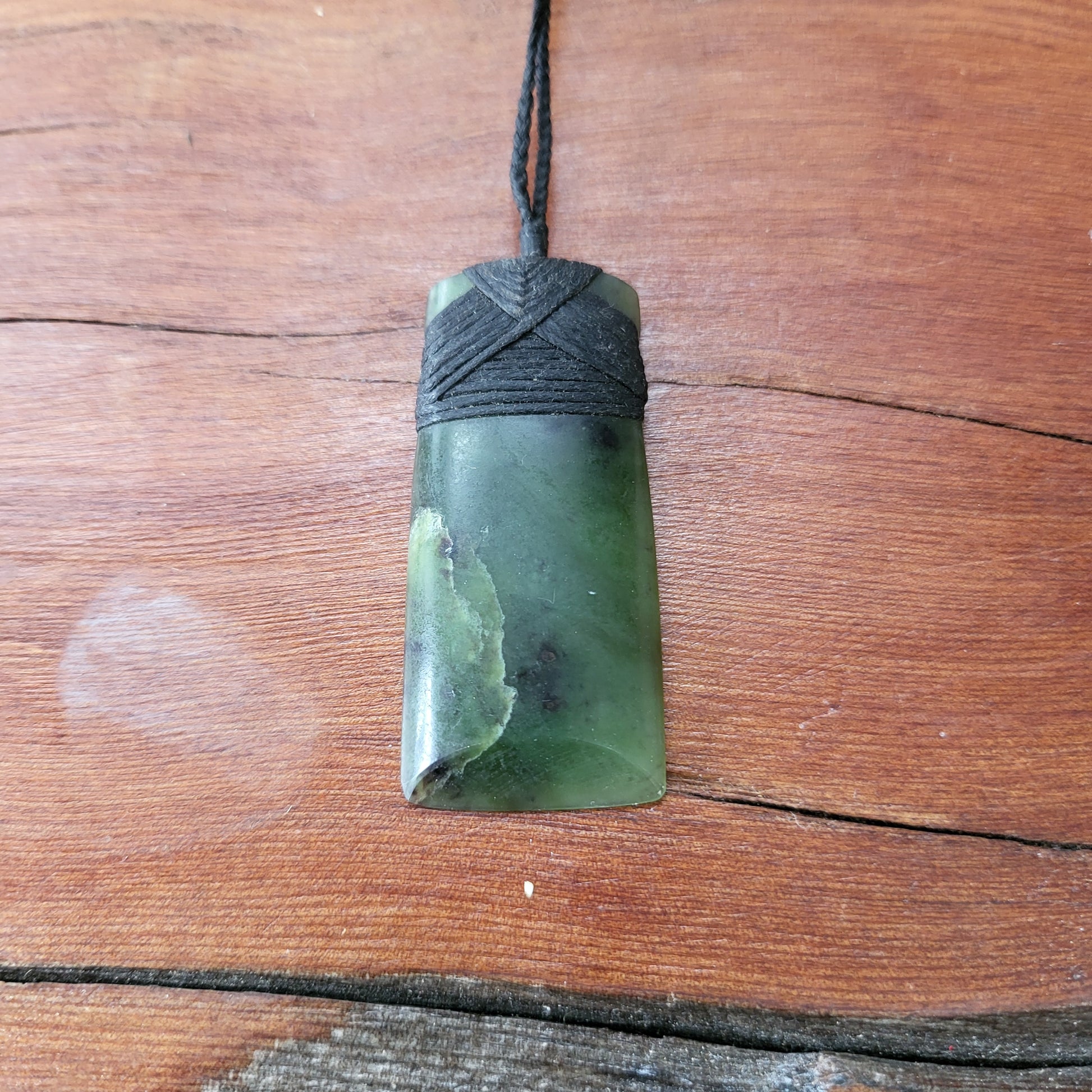 carved pounamu toki (adze) necklace, beautiful colour variations, on black cord