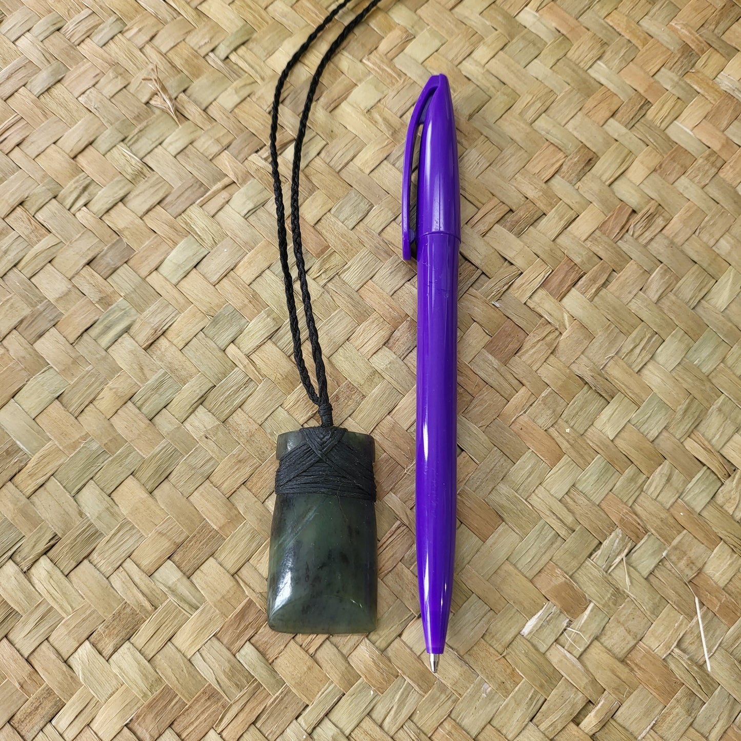 carved pounamu toki (adze) necklace, beautiful colour variations, on black cord