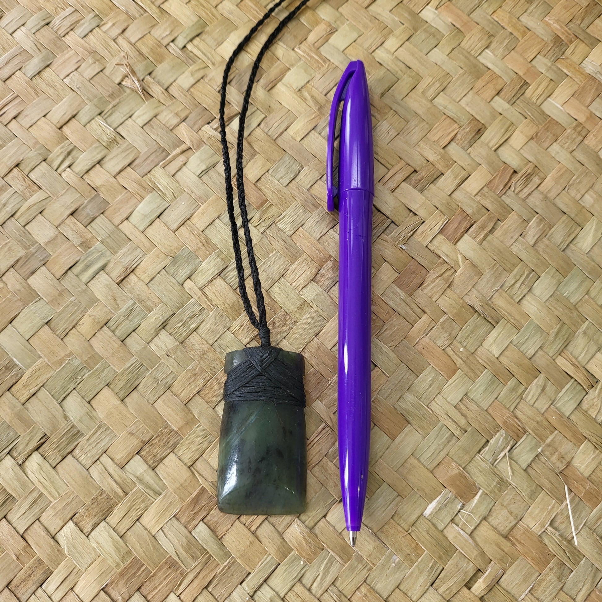 carved pounamu toki (adze) necklace, beautiful colour variations, on black cord