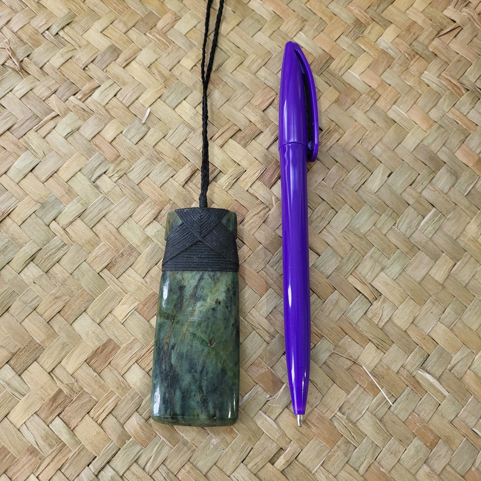 carved pounamu toki (adze) necklace, beautiful colour variations, on black cord