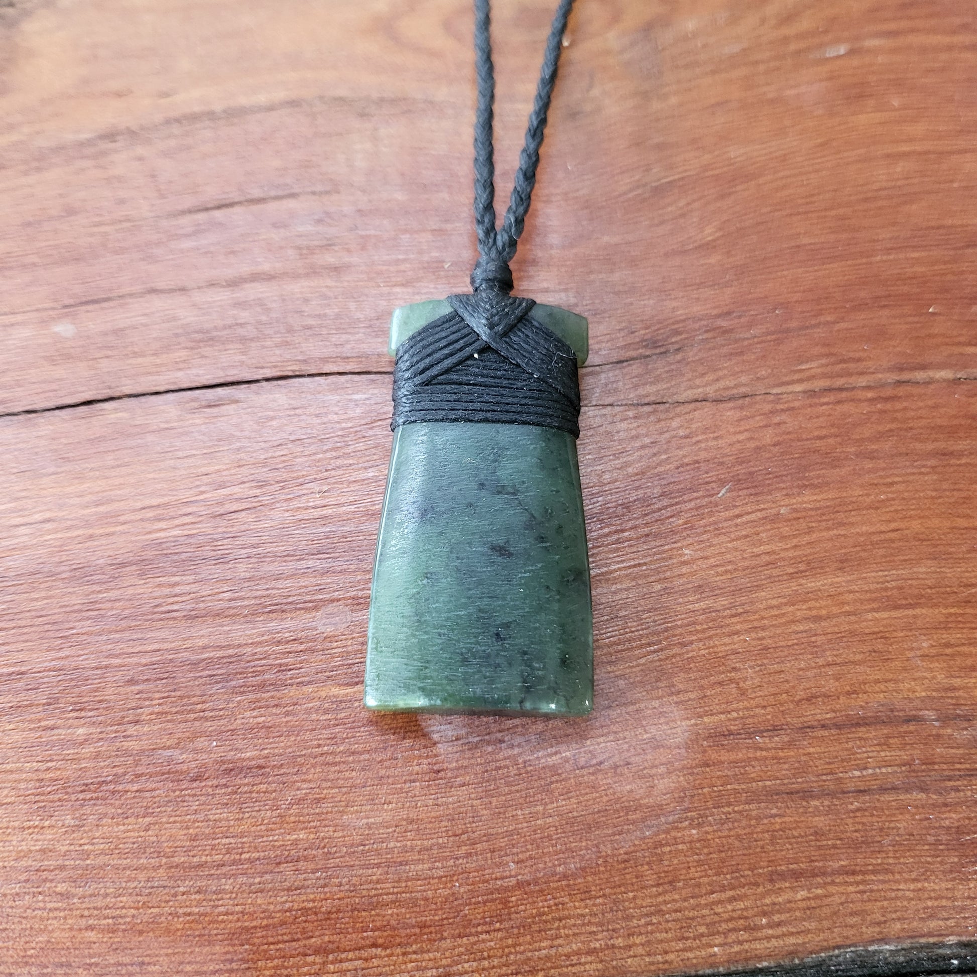 carved pounamu toki (adze) necklace, on black cord