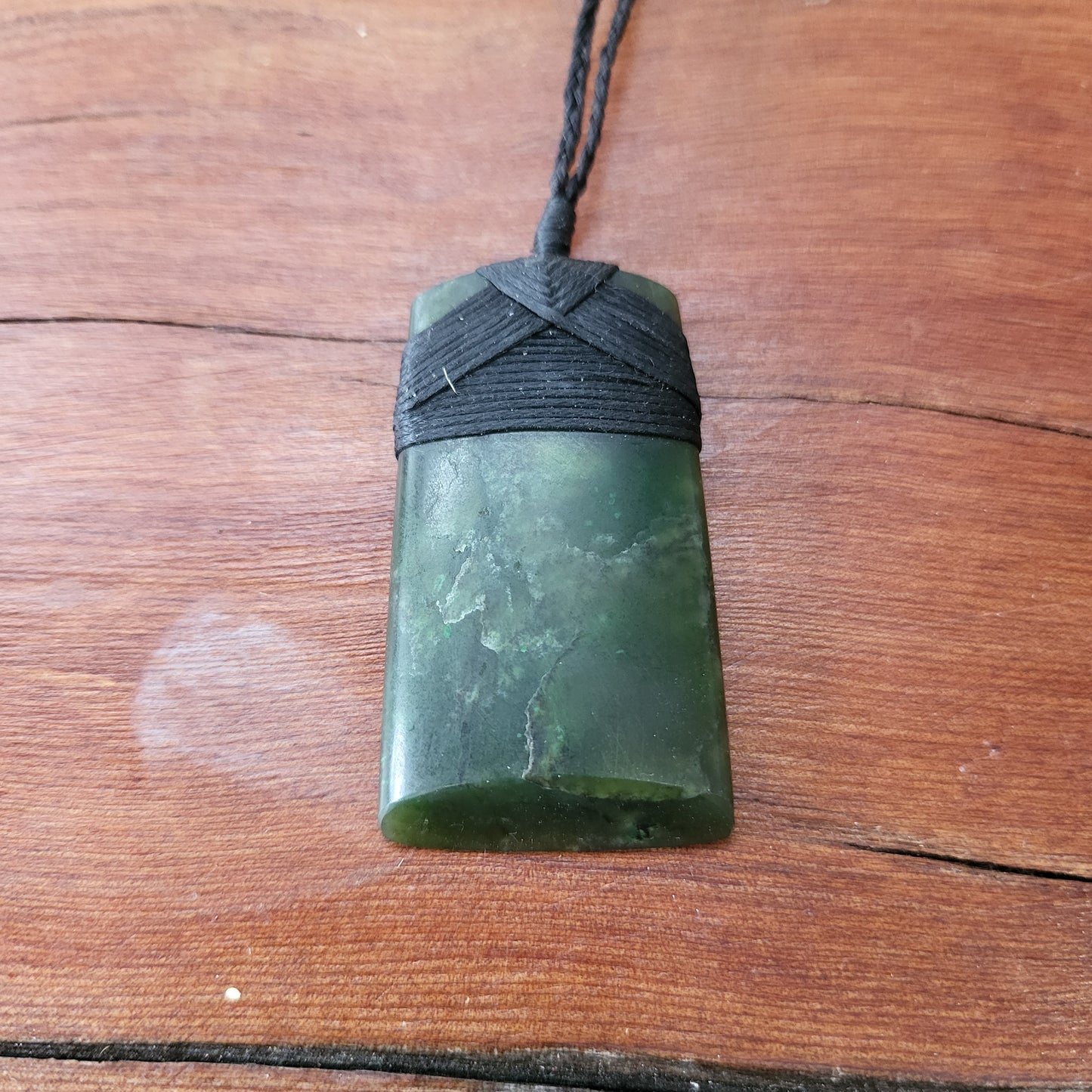 carved pounamu toki (adze) necklace, beautiful colour variations, on black cord