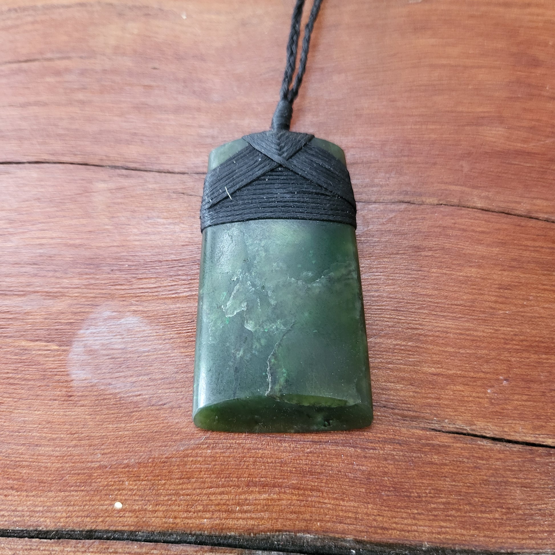 carved pounamu toki (adze) necklace, beautiful colour variations, on black cord