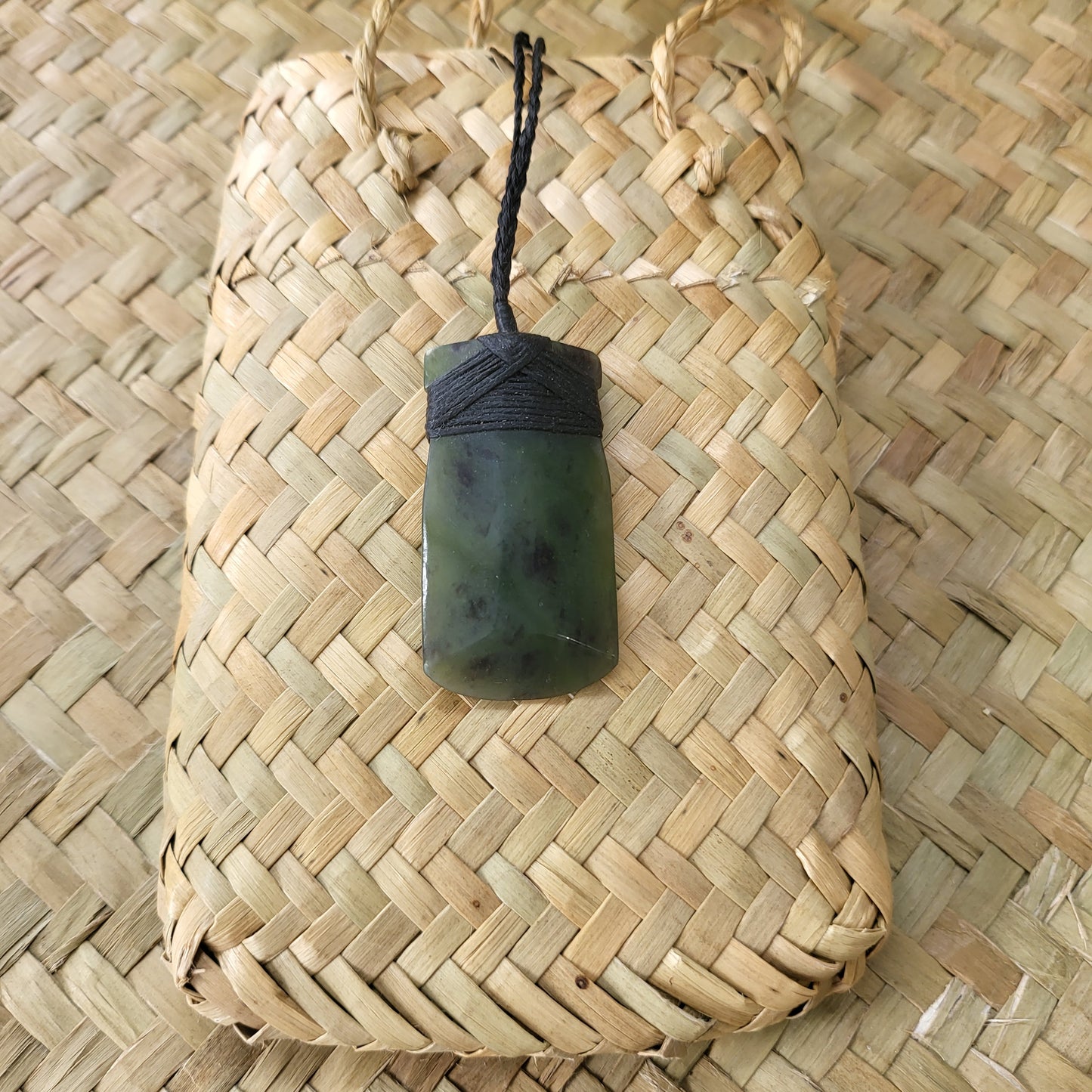 carved pounamu toki (adze) necklace, on black cord