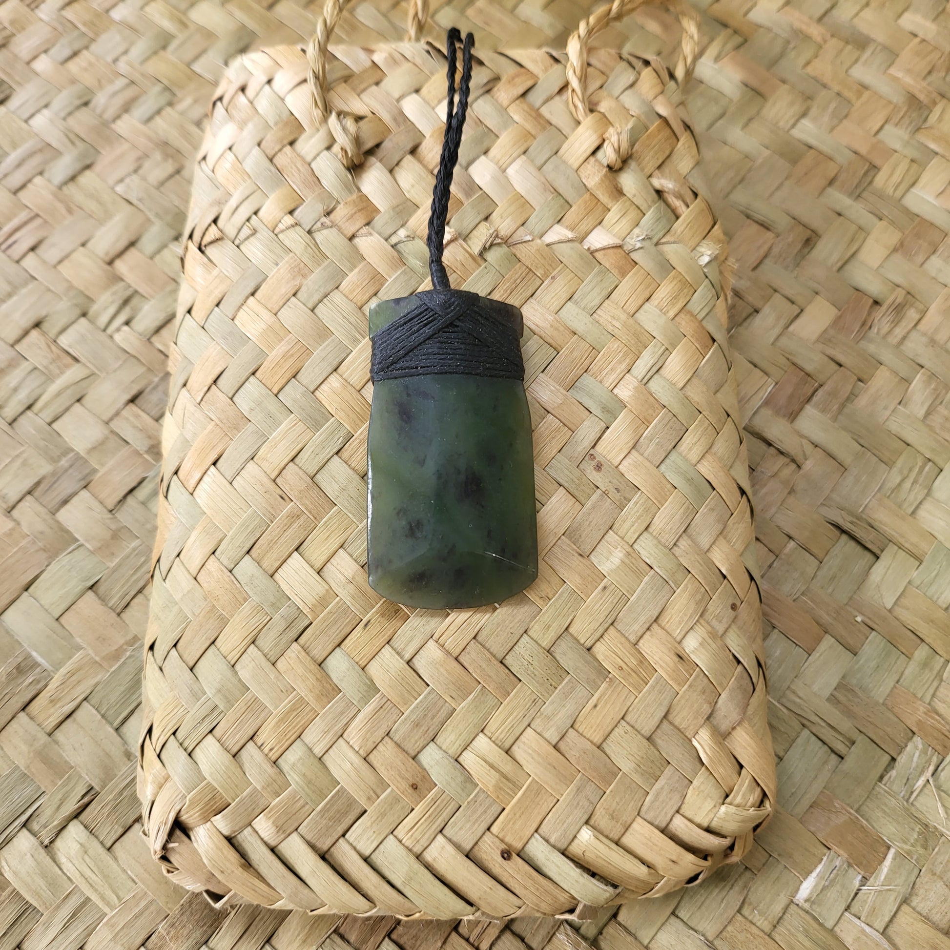 carved pounamu toki (adze) necklace, on black cord