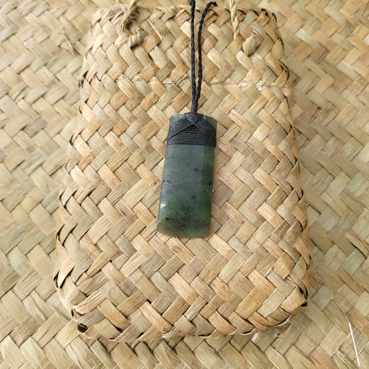 carved pounamu toki (adze) necklace, on black cord