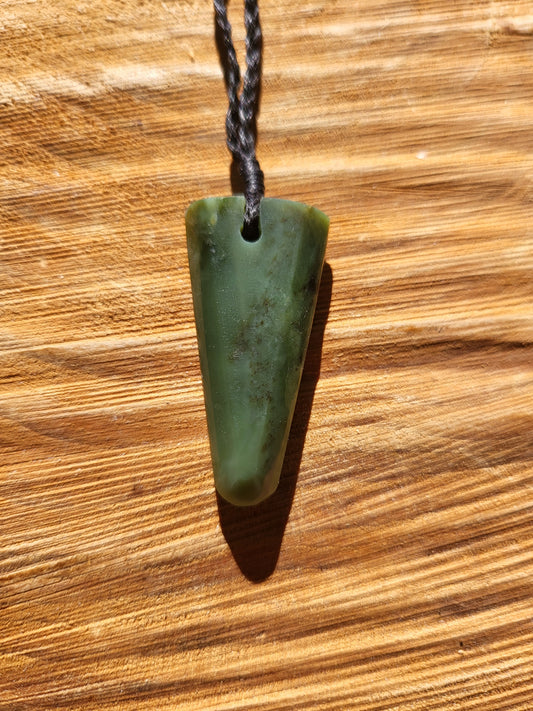 small carved pounamu toki (adze) necklace on black cord