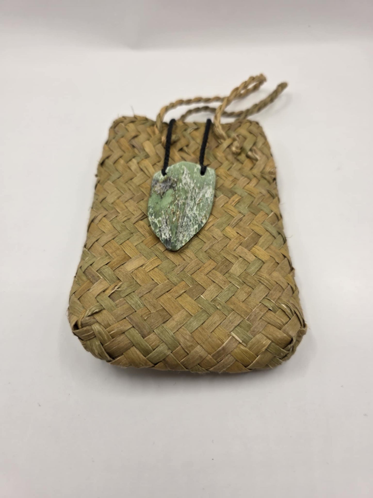 carved pounamu chest plate necklace on black cord