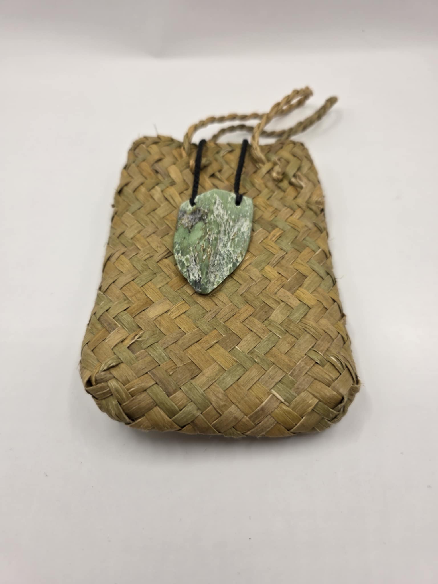 carved pounamu chest plate necklace on black cord