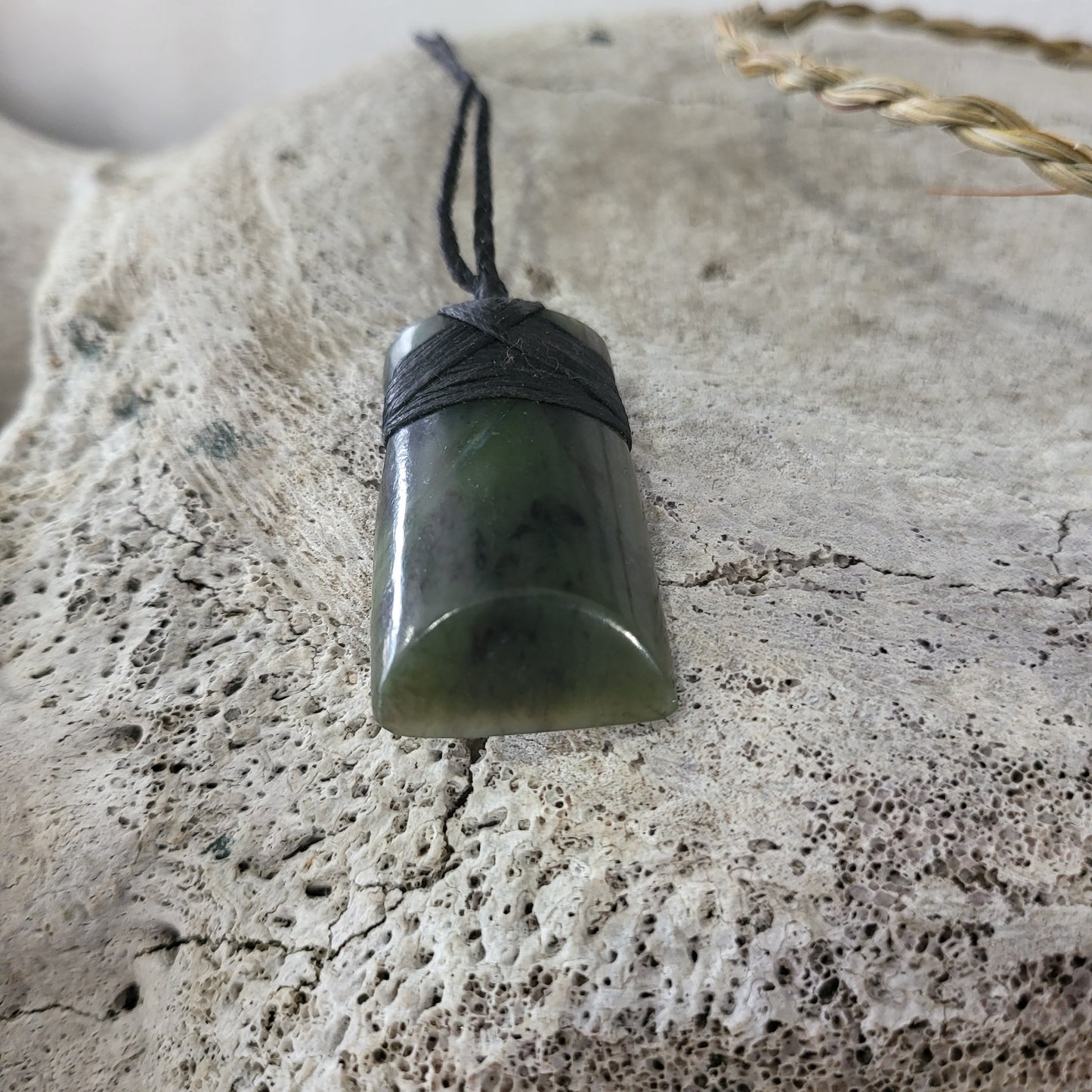 carved pounamu toki (adze) necklace, beautiful colour variations, on black cord