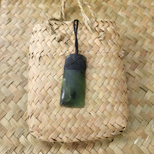 carved pounamu toki (adze) necklace, beautiful colour variations, on black cord
