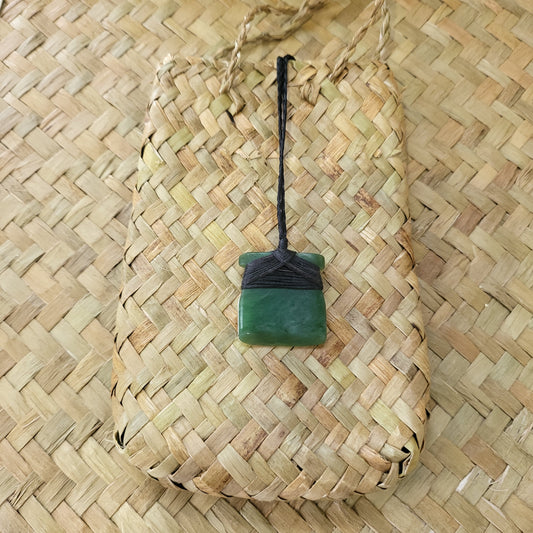 small carved pounamu toki (adze) necklace, on black cord
